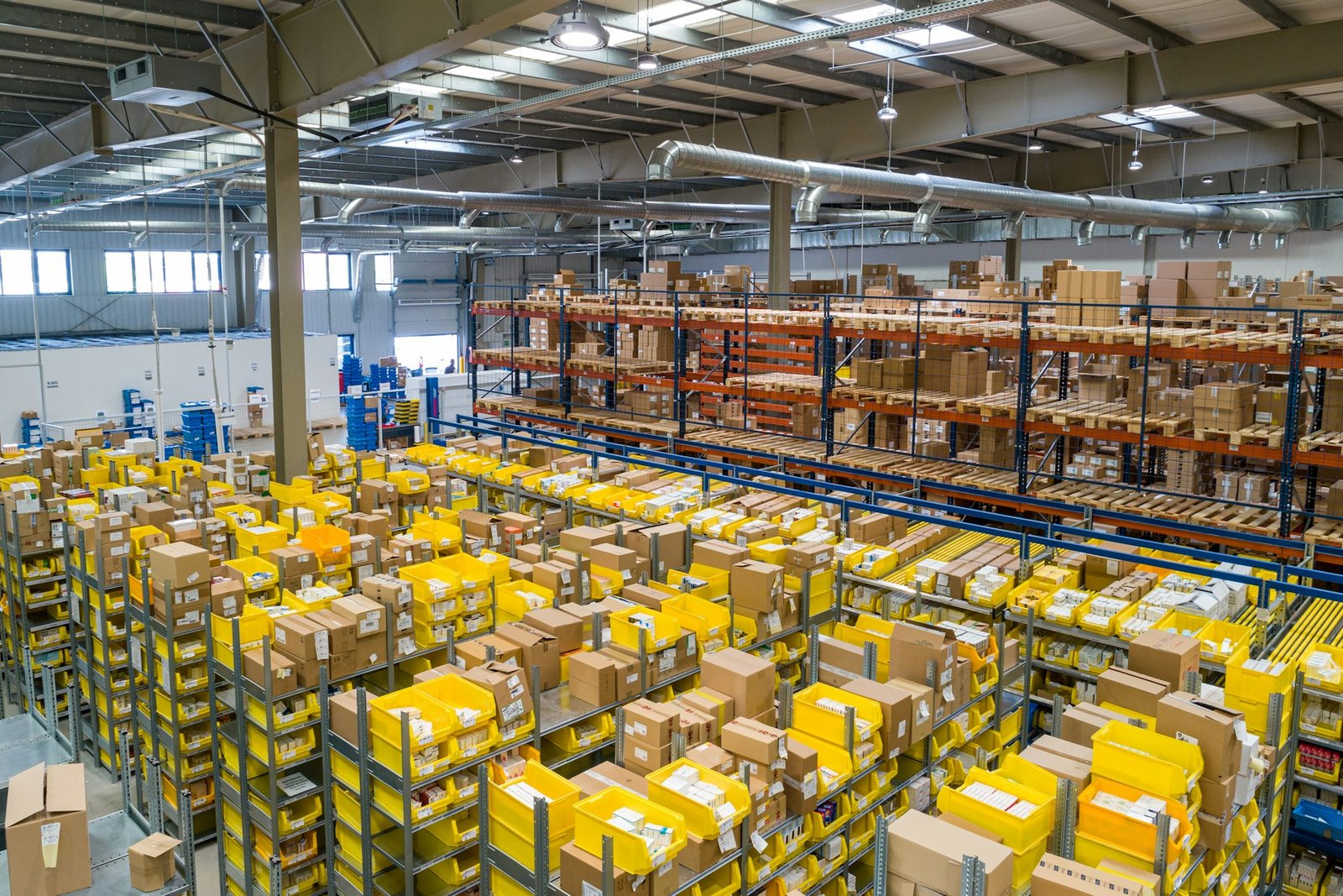 Warehouse aisles with organized pallets and industrial lighting